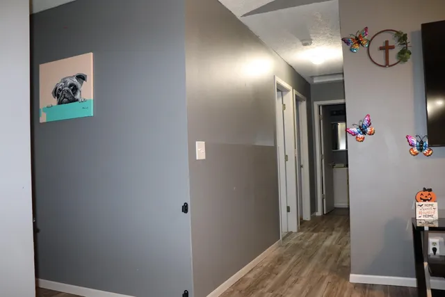 a view of hallway with wooden floor