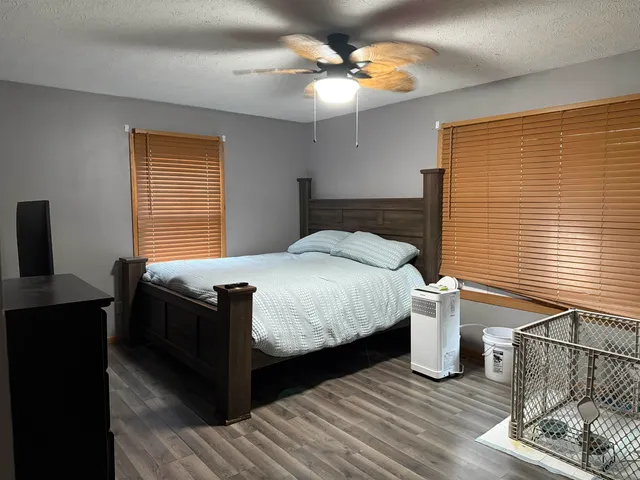 a bed sitting in a bedroom next to a window