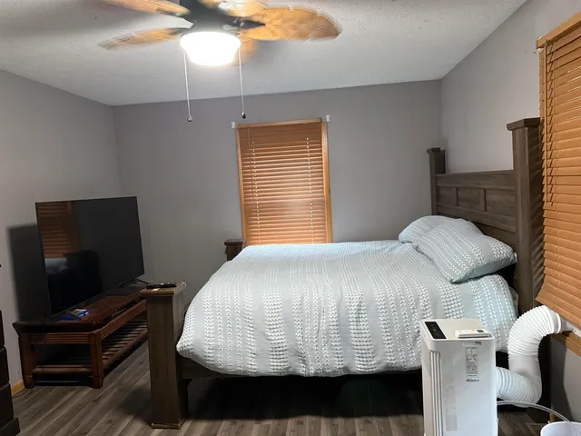 a bedroom with a bed and flat screen tv
