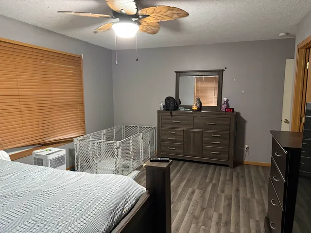 a bedroom with a bed and a dresser