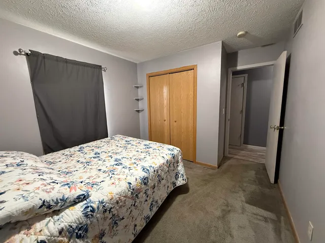 a bedroom with a bed and a mirror