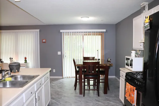 a view of a dining room with furniture and window