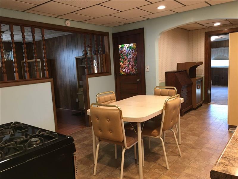 411 Ridge Avenue Canonsburg, PA 15317 - Photo 7 of 17 This kitchen view shows a kind-of open concept into the dining room. The door with the stained glass is the mudroom/extra room and this shows how the kitchen opens into additional space