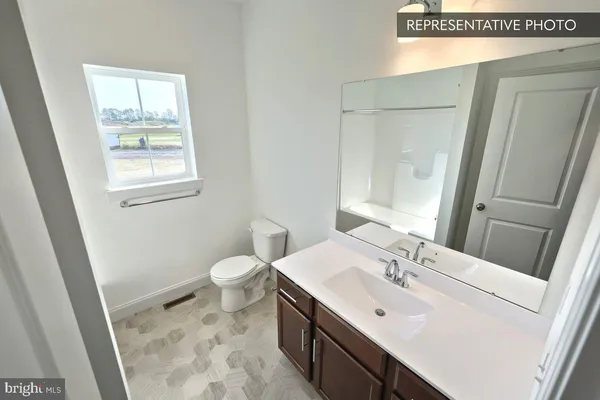 a bathroom with a sink a toilet and vanity
