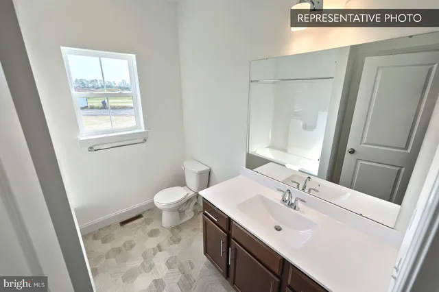a bathroom with a sink a toilet and vanity