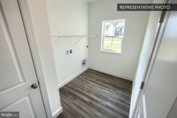 a view of a room with wooden floor and white walls
