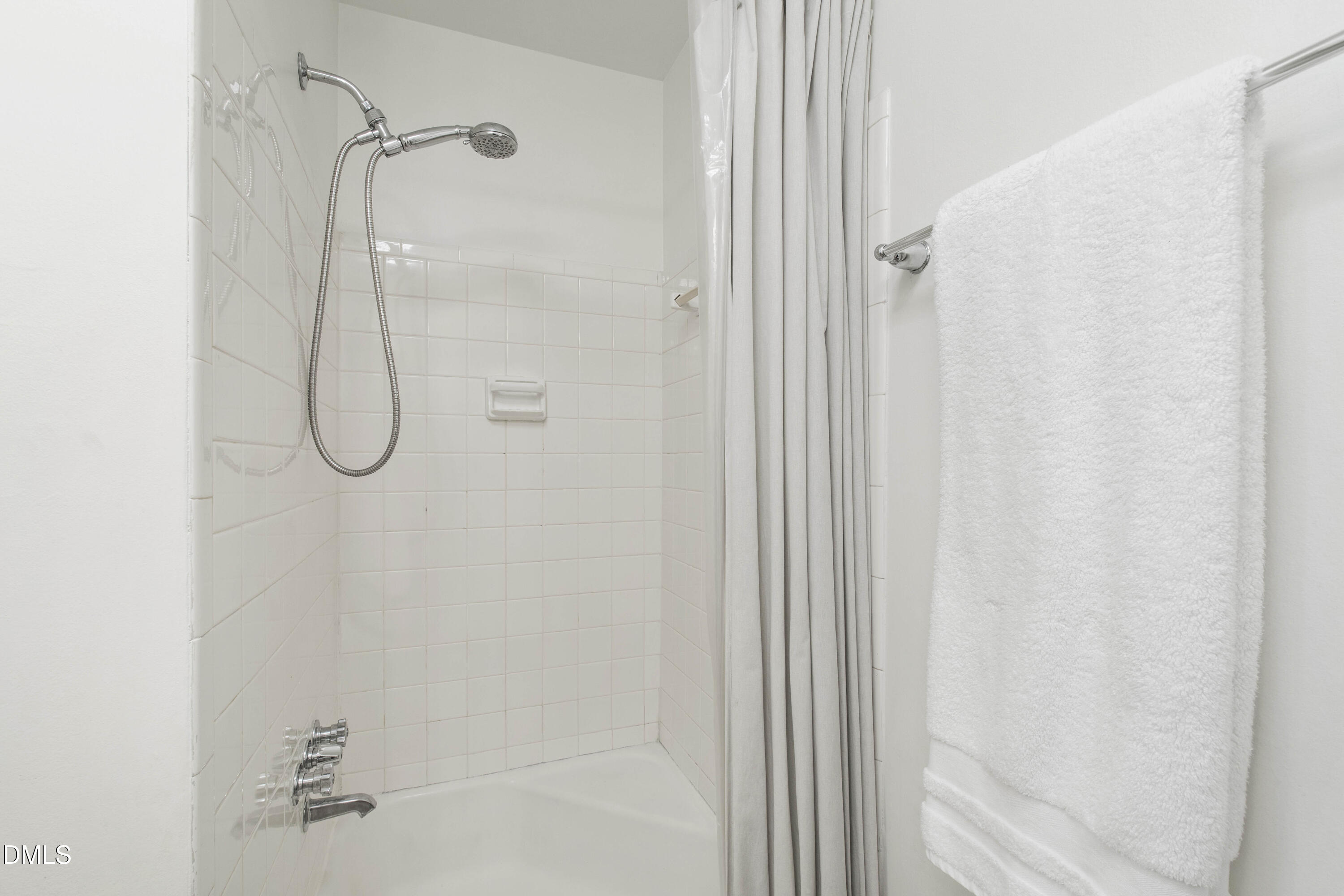 304 Latimer Road Raleigh, NC 27609 - Photo 12 of 42 a bathroom with a glass shower door