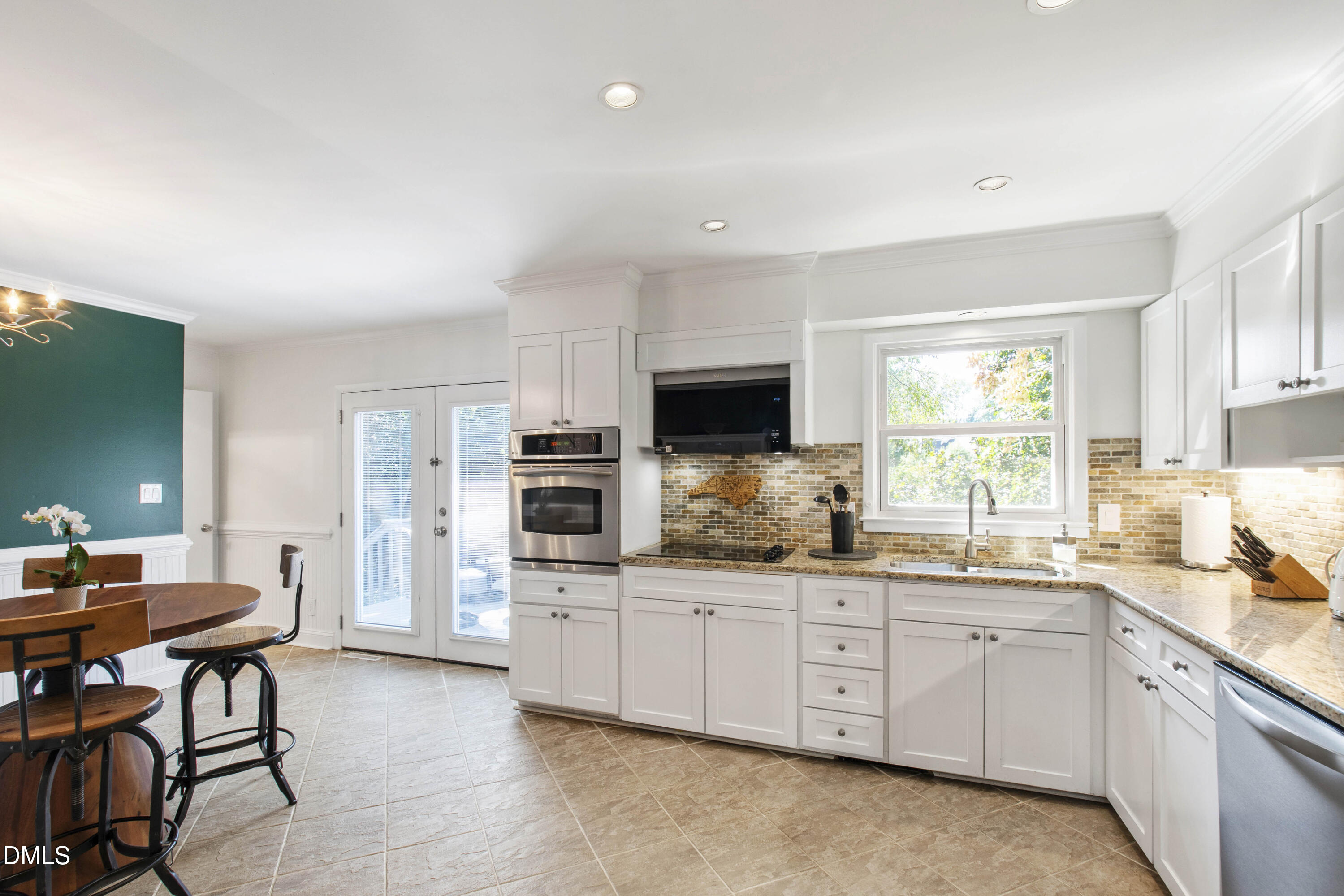 304 Latimer Road Raleigh, NC 27609 - Photo 18 of 42 a kitchen with white cabinets and sink