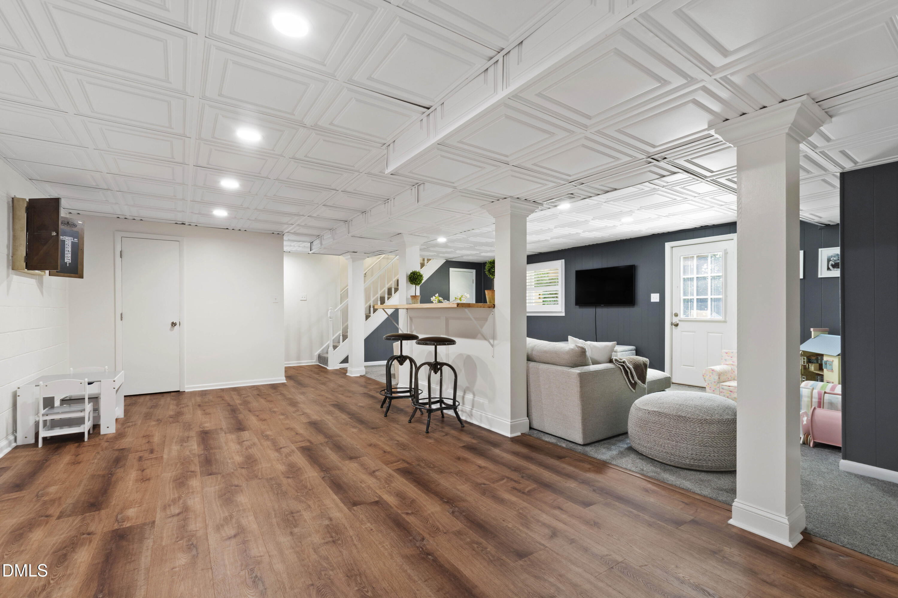304 Latimer Road Raleigh, NC 27609 - Photo 28 of 42 a living room with furniture and a flat screen tv