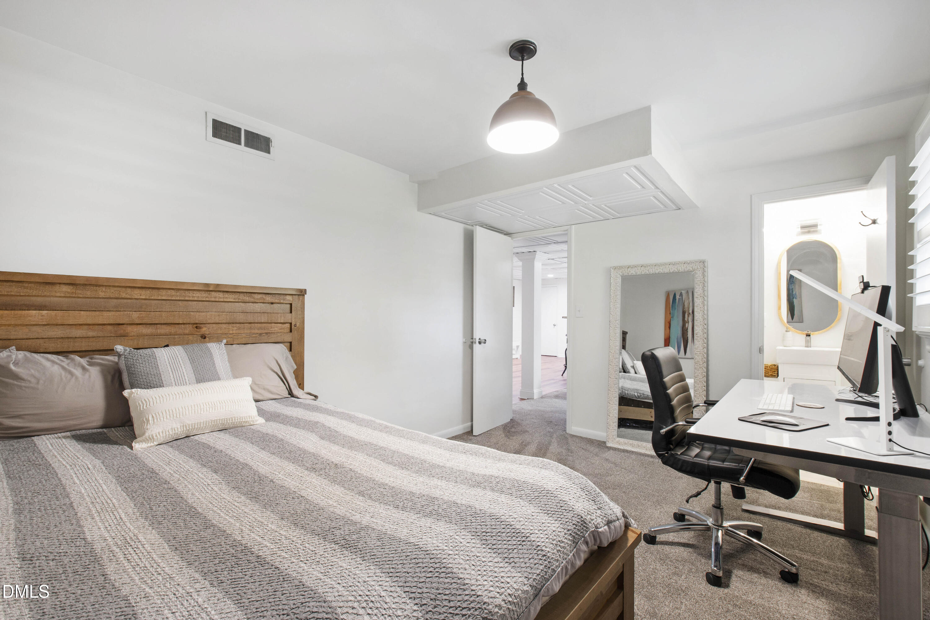 304 Latimer Road Raleigh, NC 27609 - Photo 32 of 42 a bedroom with a bed and a table