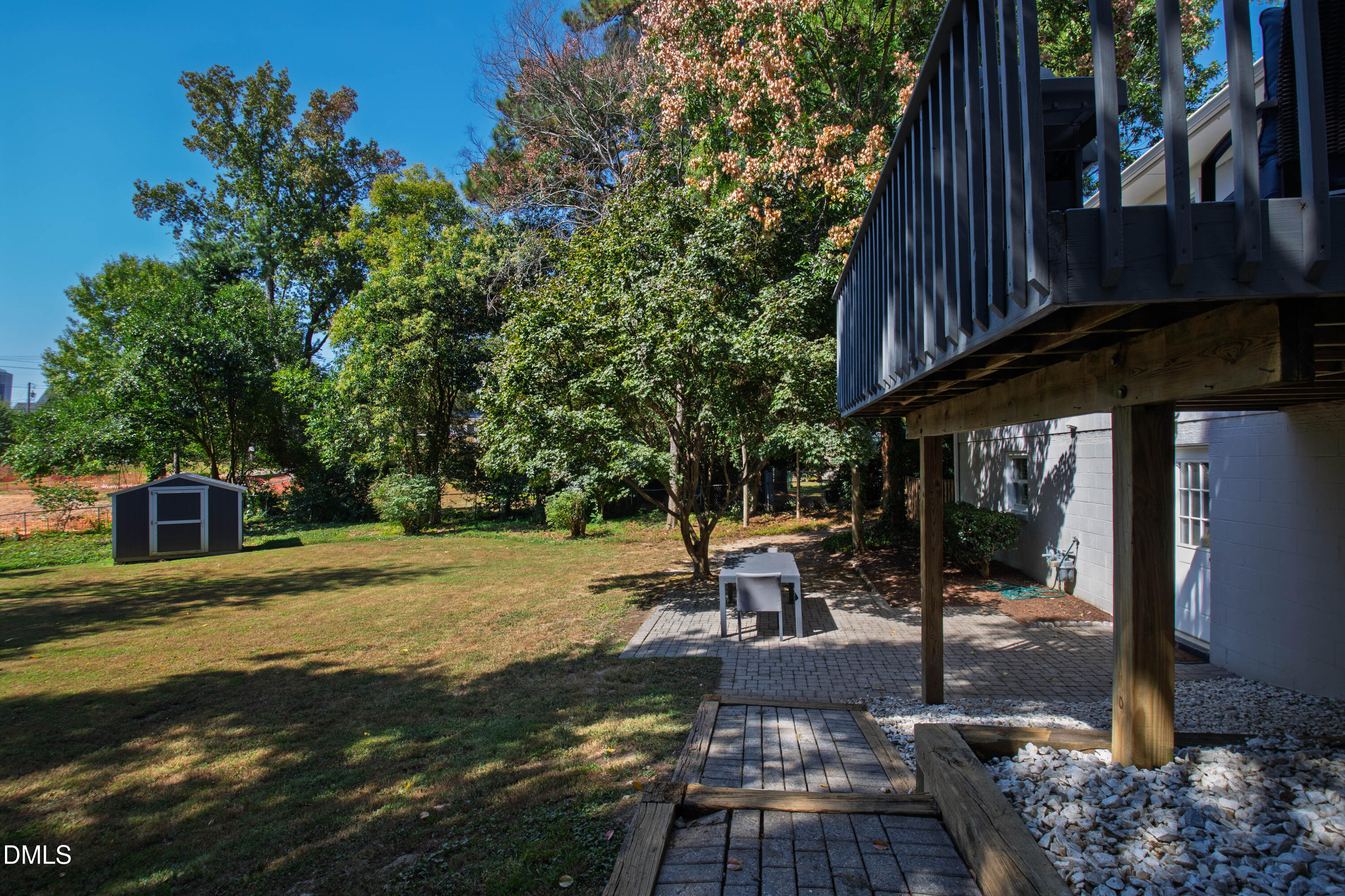 304 Latimer Road Raleigh, NC 27609 - Photo 37 of 42 a view of a patio with table and chairs potted plants and large tree