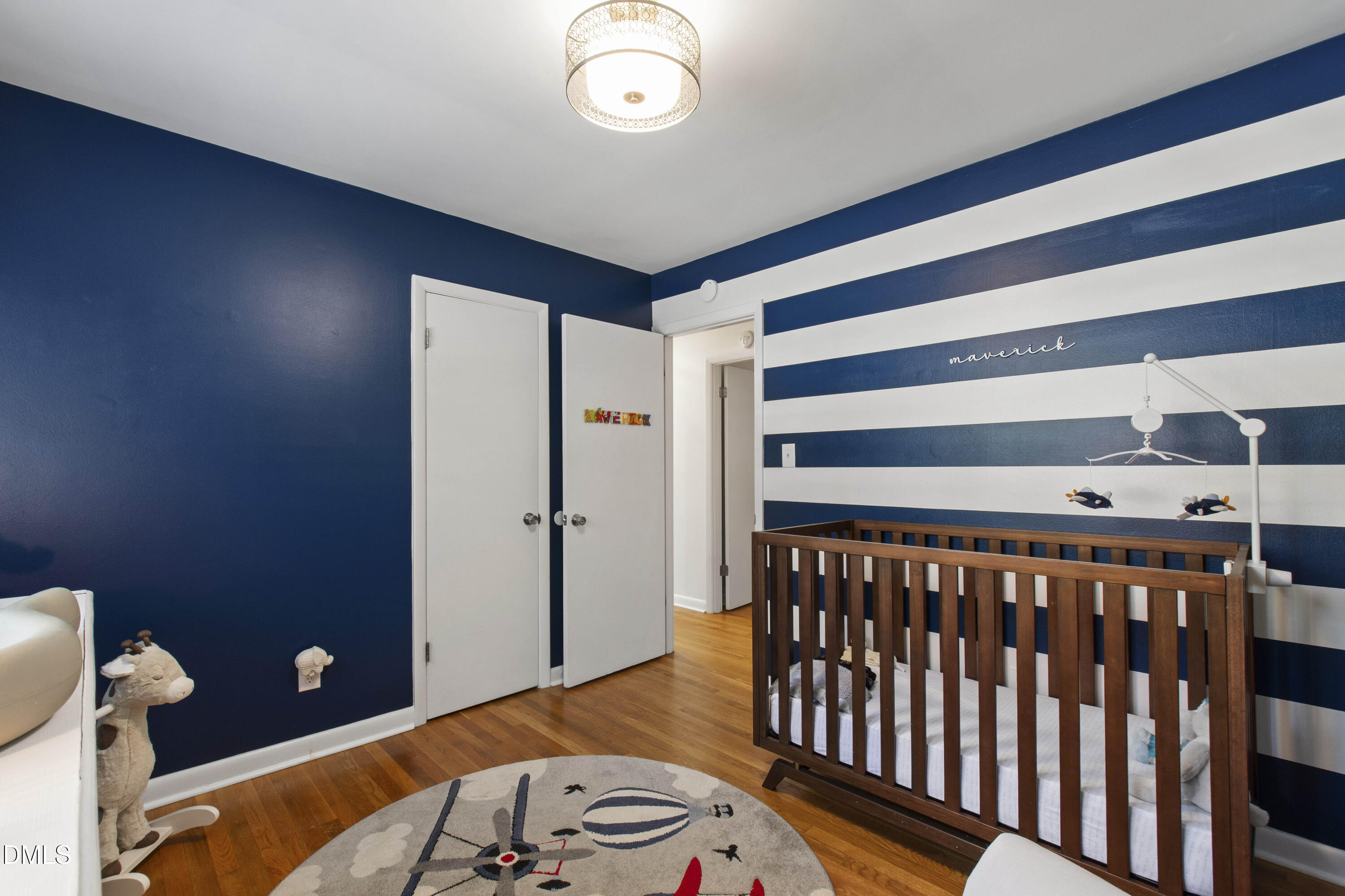 304 Latimer Road Raleigh, NC 27609 - Photo 10 of 42 a bedroom with a bed and wooden floor