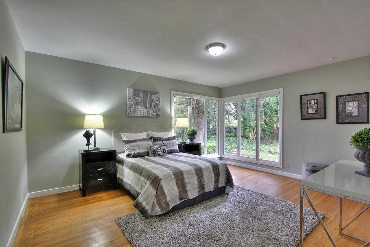 35 Selby Lane Atherton, CA 94027 - Photo 14 of 30 a bedroom with a bed and glass window