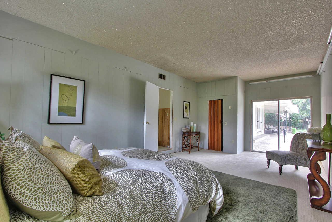 35 Selby Lane Atherton, CA 94027 - Photo 24 of 30 a bedroom with a bed and glass windows