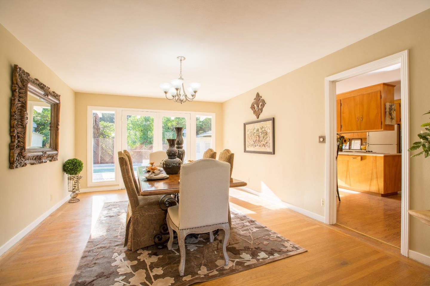 35 Selby Lane Atherton, CA 94027 - Photo 9 of 30 a dining room with furniture a chandelier and wooden floor