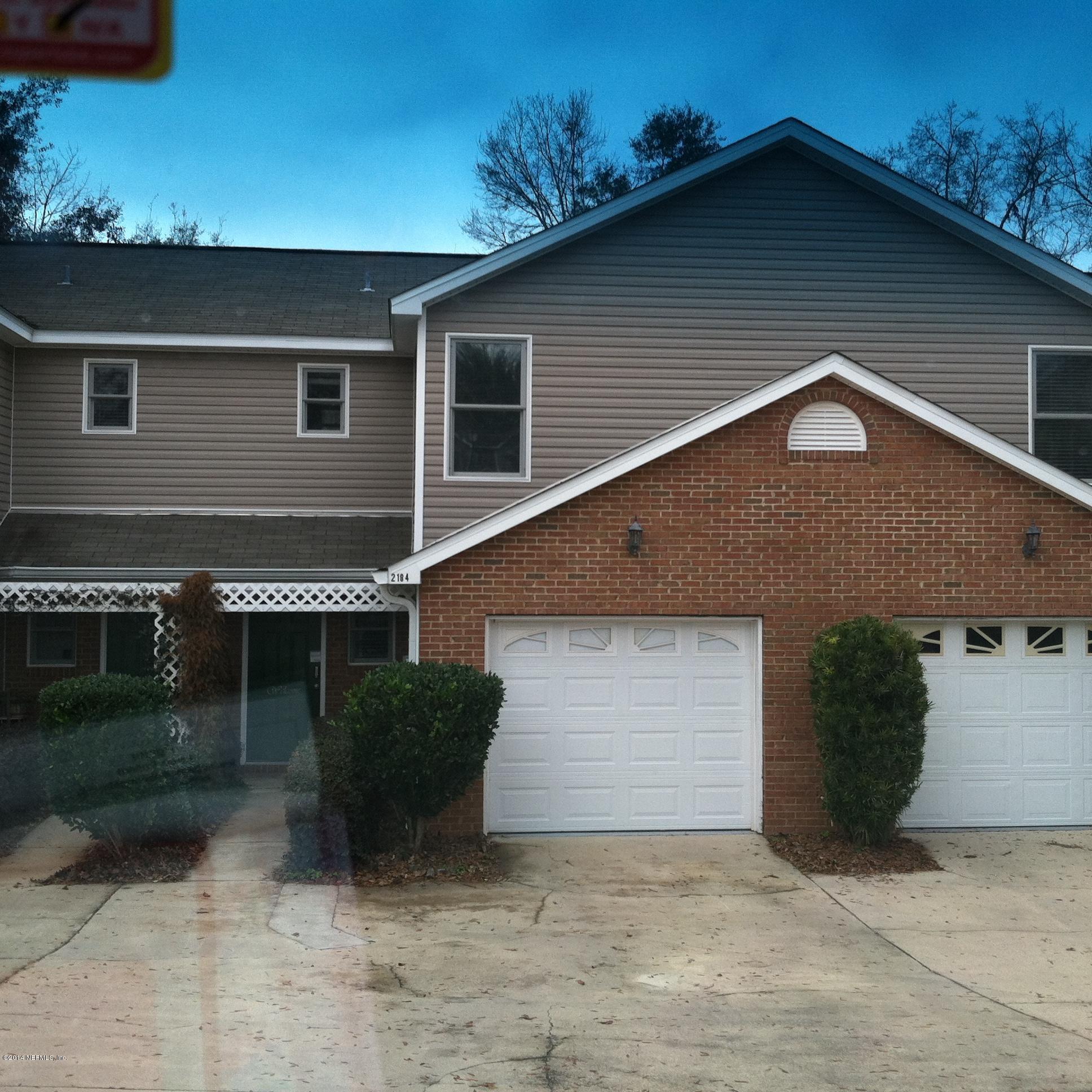 2184 Delta Way Tallahassee, FL 32303 - Photo 1 of 1 a front view of a house with a yard and garage