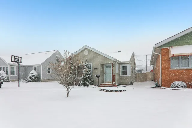 a view of a house with a snow in the background