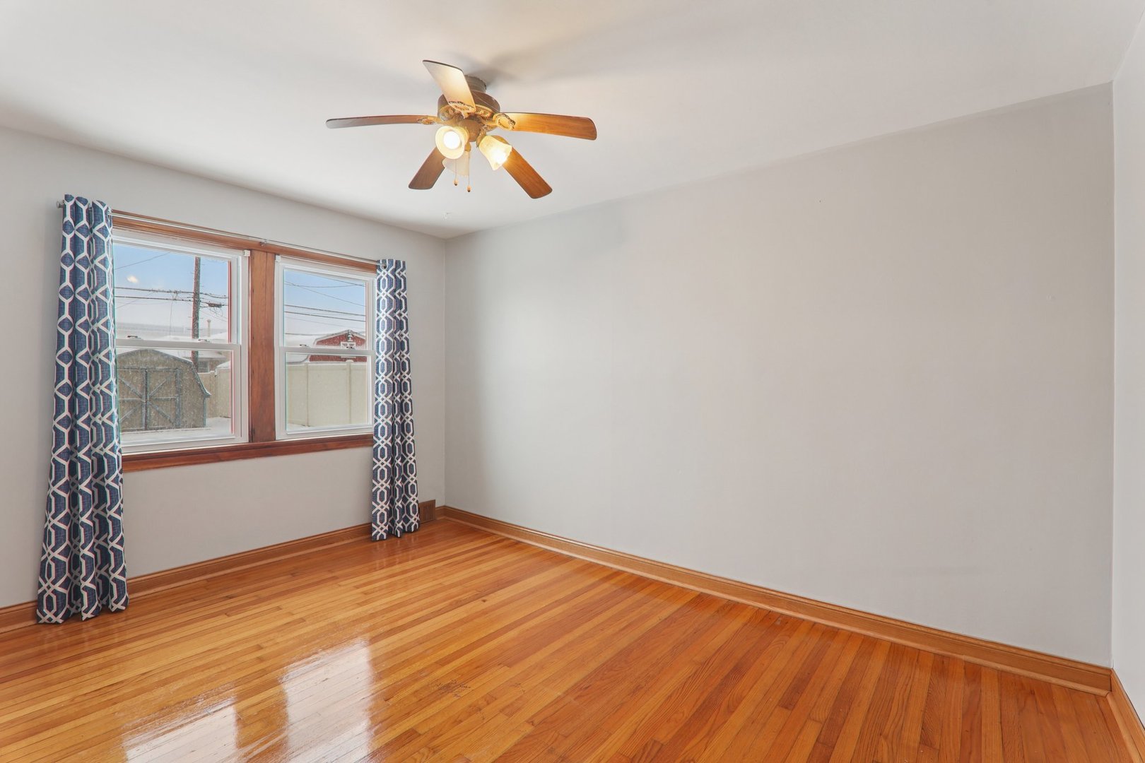 8033 Austin Avenue Burbank, IL 60459 - Photo 13 of 19 a view of empty room with wooden floor and fan