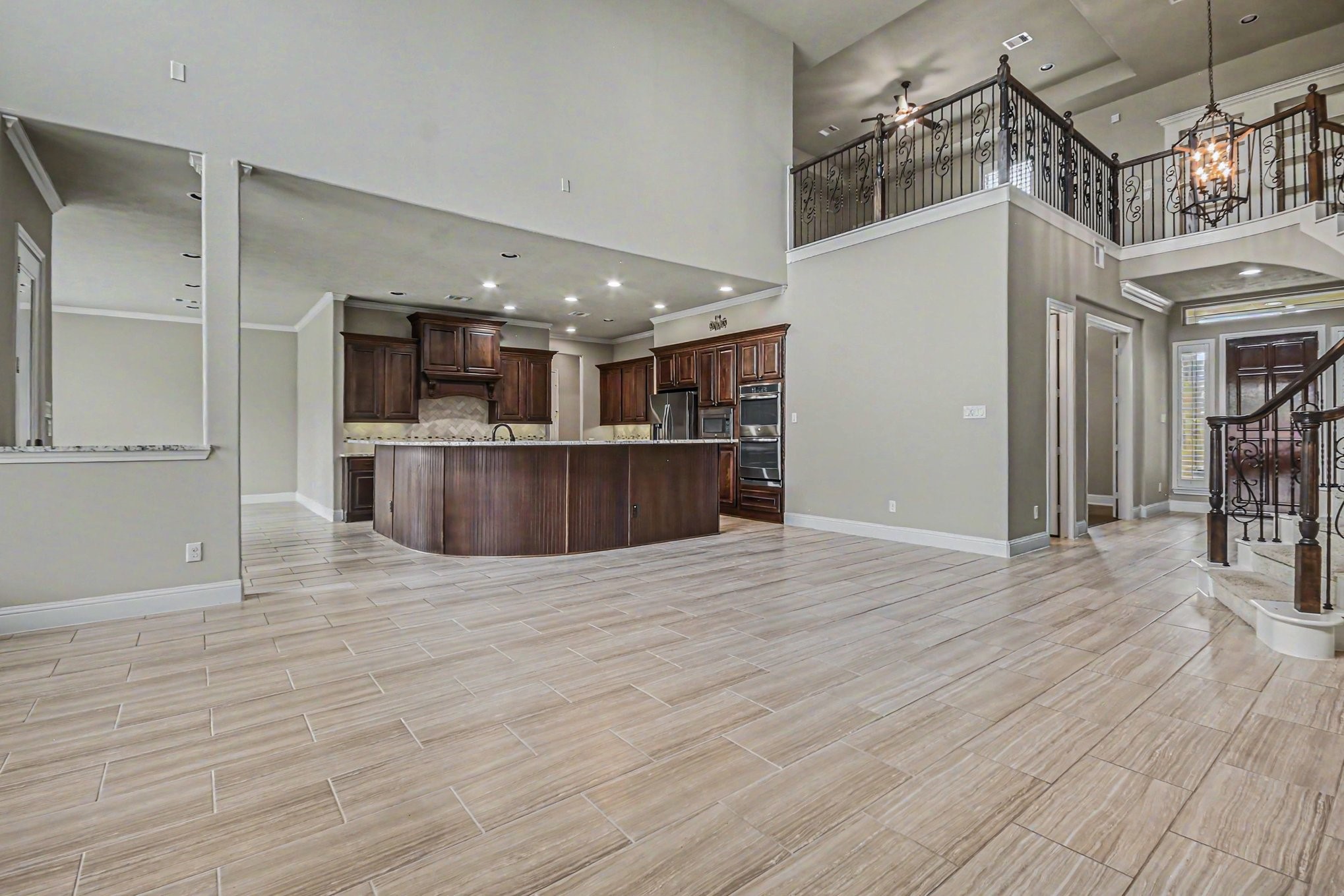 3310 Ralston Edge Lane Houston, TX 77059 - Photo 14 of 50 a view of a living room and kitchen with a wooden floor