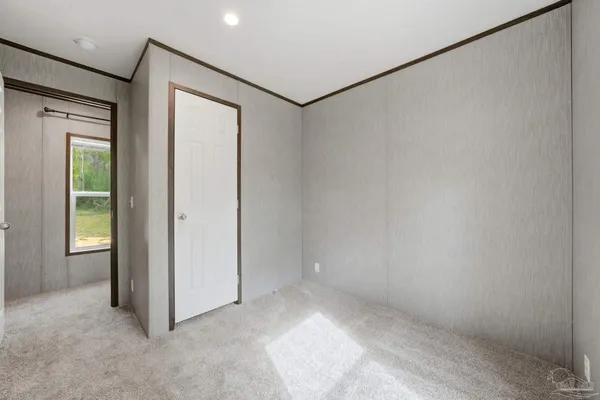 an empty room with windows and closet