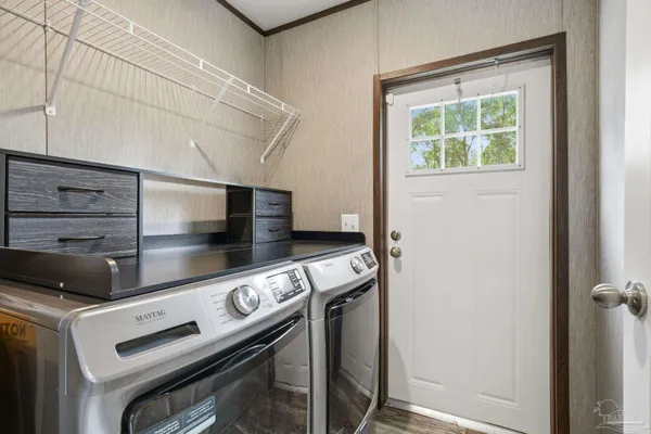 a view of a house with a yard and a large tree