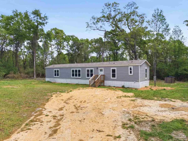 a view of a house with swimming pool next to a yard