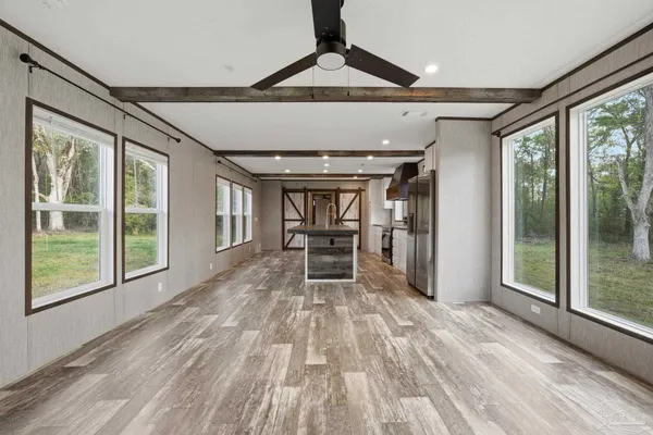 a view of a livingroom with furniture window and wooden floor