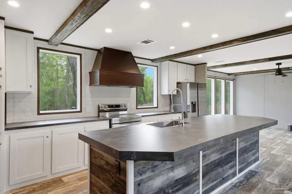 a kitchen with stainless steel appliances granite countertop a sink and stove