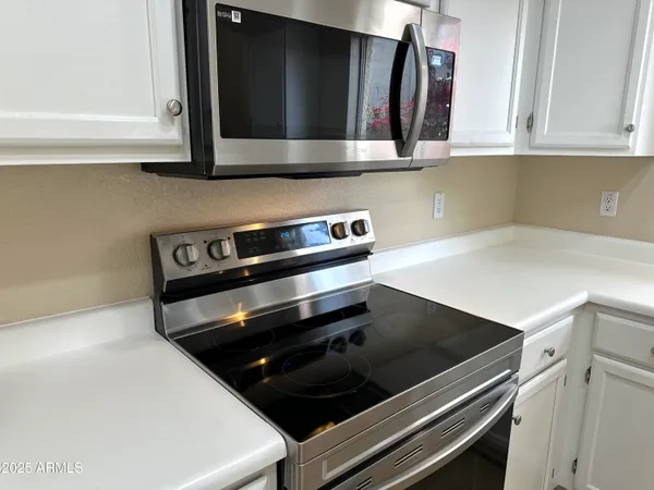 a kitchen with a sink cabinets and window