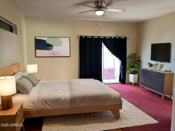a bedroom with a bed and a potted plant