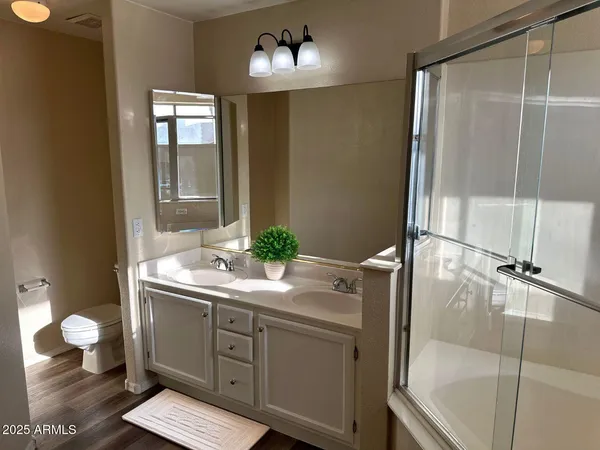 a view of empty room with wooden floor and window