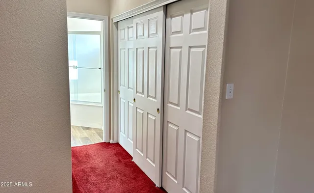 a bedroom with a bed and a potted plant