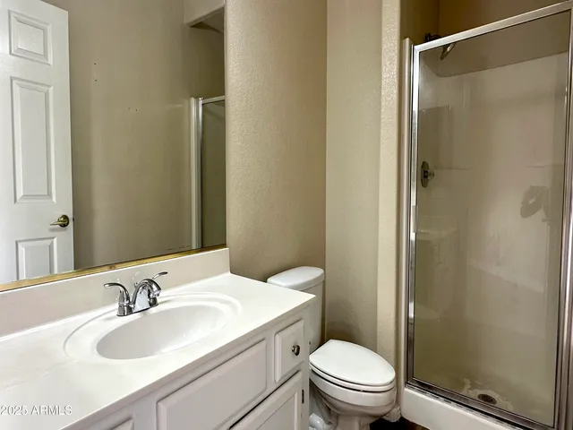 a view of empty room with wooden floor and window