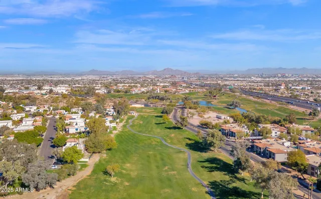 an aerial view of a house a garden and swimming pool