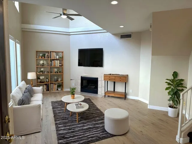a living room with furniture a fireplace and a flat screen tv