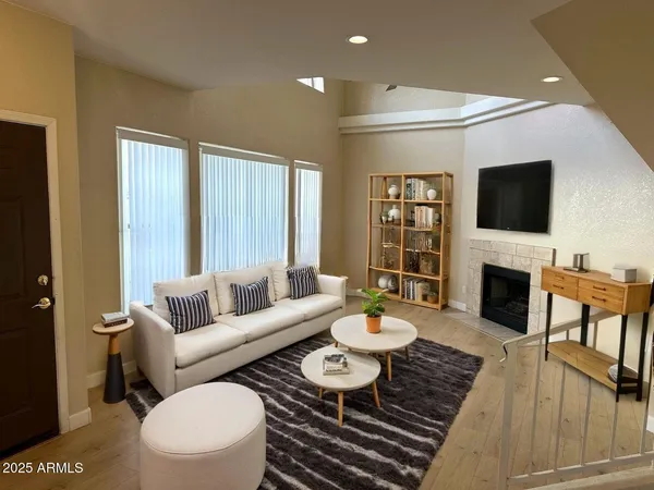 a living room with furniture a fireplace and a flat screen tv