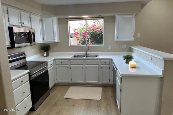 a kitchen with stainless steel appliances a sink stove and microwave
