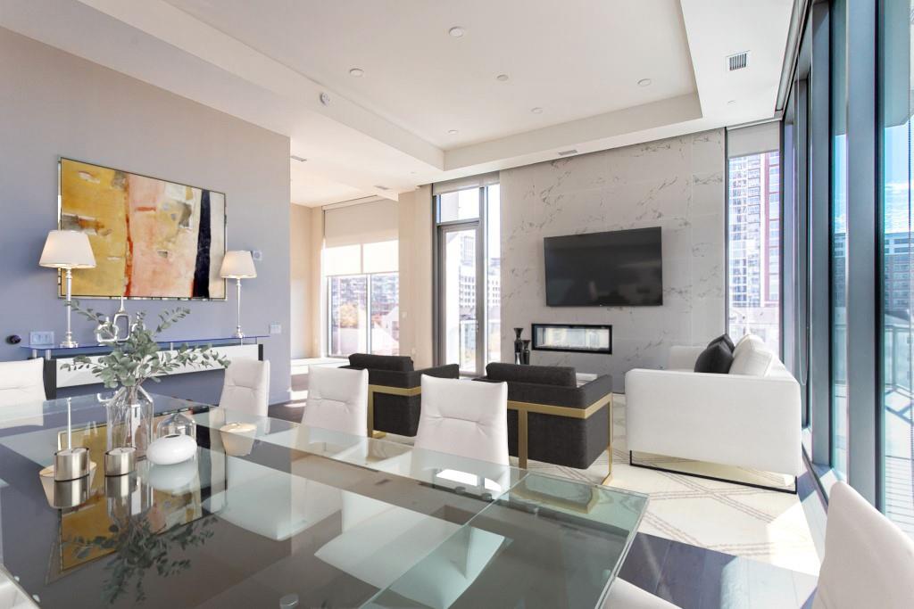 40 West 12th Atlanta, GA 30309 - Photo 1 of 1 a living room with furniture a flat screen tv and a floor to ceiling window