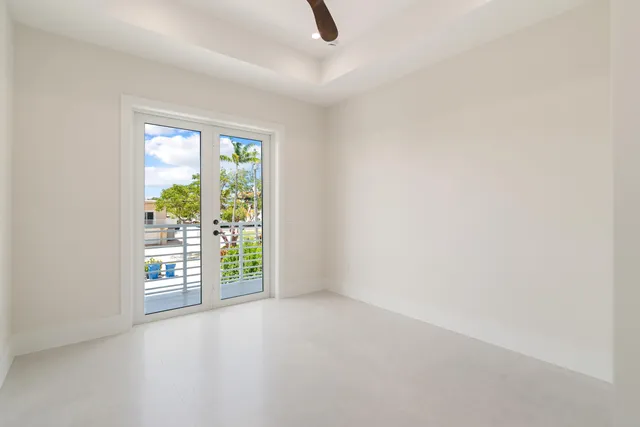 a spacious bathroom with a granite countertop sink a toilet and bathtub