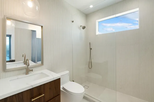 a spacious bathroom with a granite countertop sink and a mirror