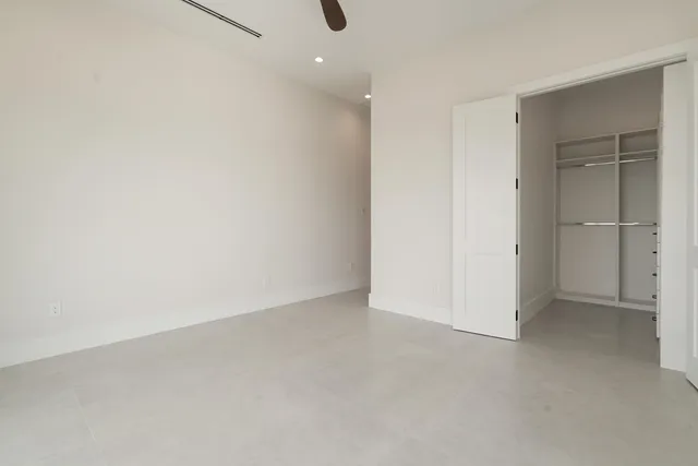 a view of a swimming pool with a patio and a yard