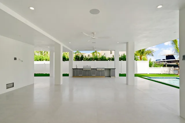 an aerial view of residential house with outdoor space and trees all around