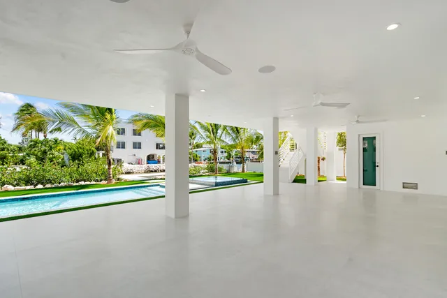 an aerial view of multiple houses with a yard
