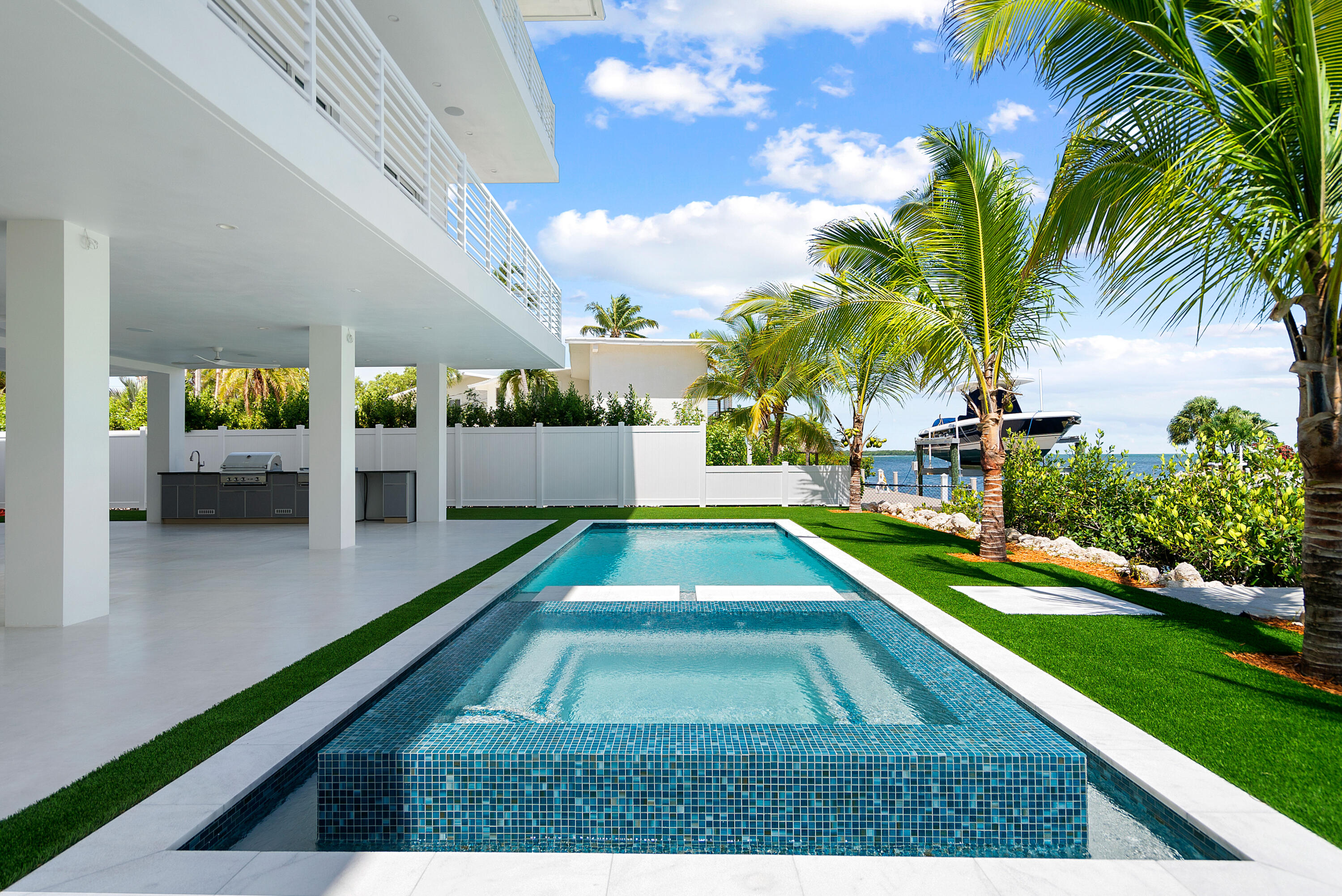 206 Plantation Avenue Tavernier, FL 33070 - Photo 46 of 81 a swimming pool with outdoor seating and trees