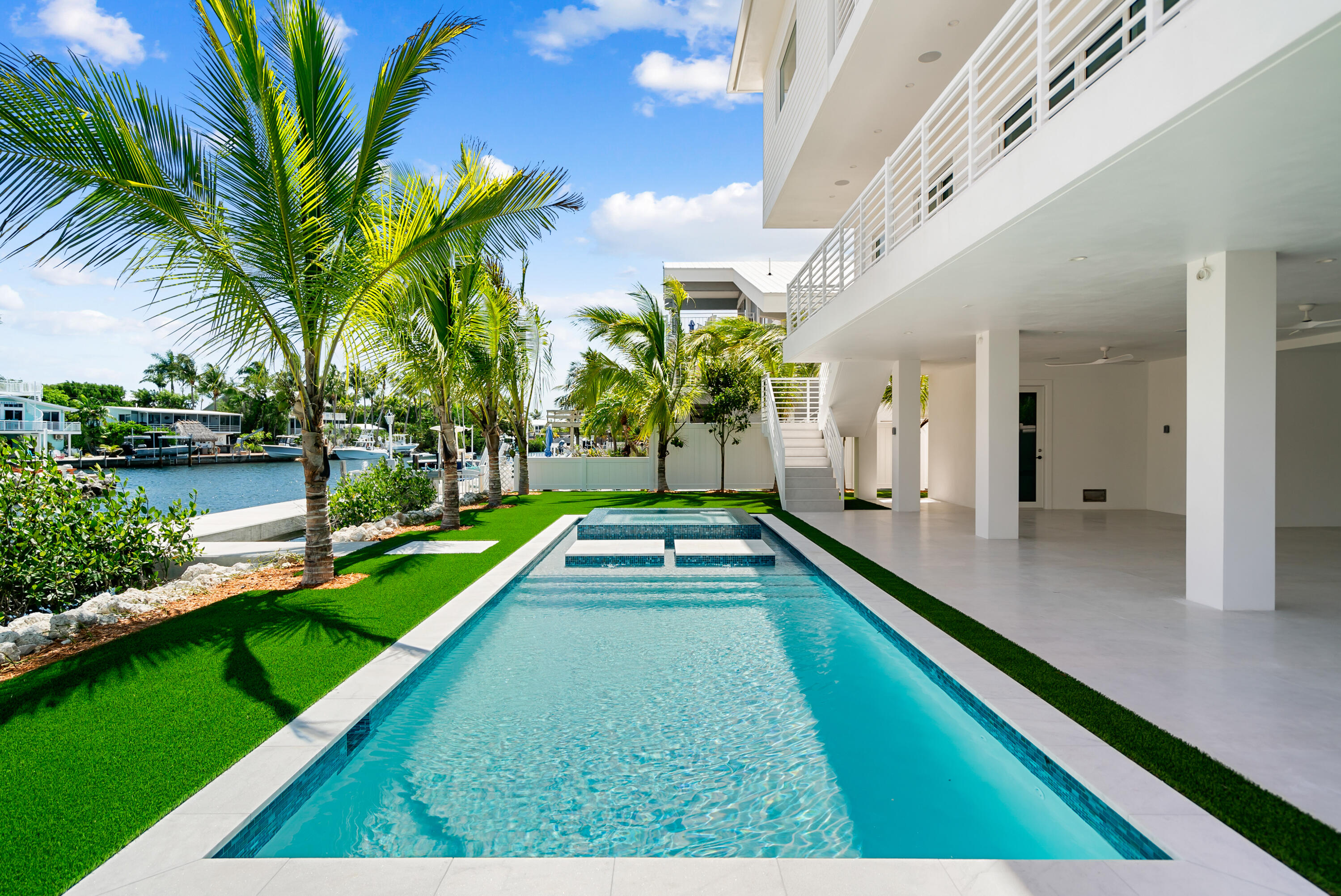 206 Plantation Avenue Tavernier, FL 33070 - Photo 49 of 81 a swimming pool with a garden view