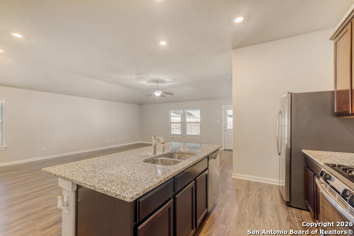 10583 Penelope Way Converse, TX 78109 - Photo 12 of 26 a kitchen with stainless steel appliances granite countertop a sink stove and refrigerator