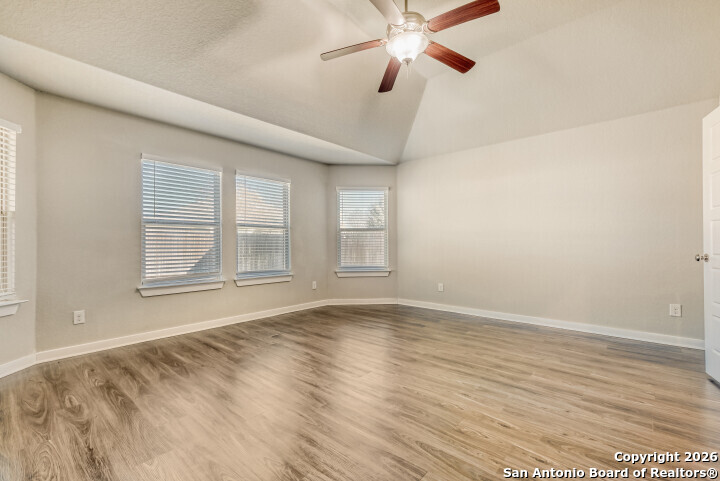 10583 Penelope Way Converse, TX 78109 - Photo 14 of 26 a view of an empty room with wooden floor and a window