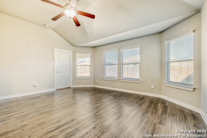10583 Penelope Way Converse, TX 78109 - Photo 15 of 26 a view of an empty room with wooden floor and a window
