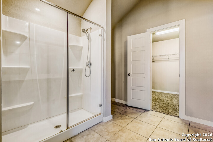 10583 Penelope Way Converse, TX 78109 - Photo 16 of 26 a bathroom with a shower and a glass door