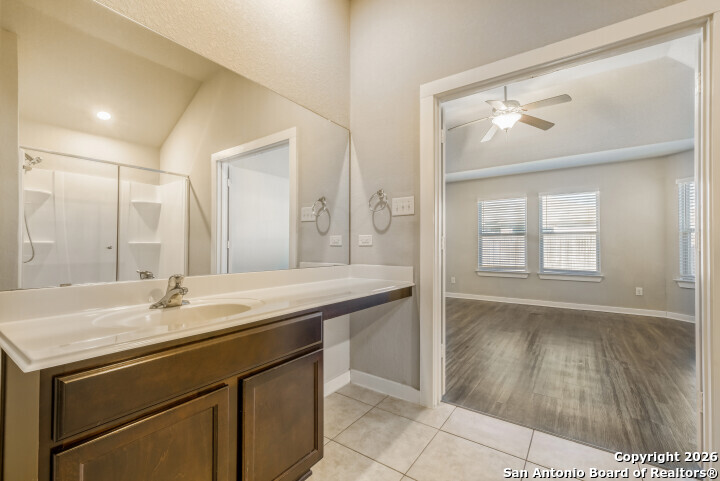 10583 Penelope Way Converse, TX 78109 - Photo 17 of 26 a bathroom with a sink a mirror and a vanity